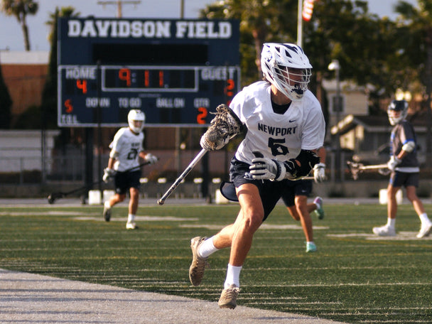 Newport Harbor Lacrosse player running with the ball