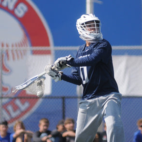 Lacrosse Goalie winding up to pass a ball